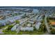 Aerial view showcases waterfront community with pool, lush landscaping and nearby water access at 238 Sun Ketch Ct # 95, Treasure Island, FL 33706