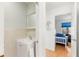 A half bathroom featuring a white vanity with sink and mirror, complemented by tiled walls with view to bedroom at 238 Sun Ketch Ct # 95, Treasure Island, FL 33706