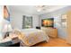 Relaxing bedroom with hardwood floors, neutral walls, a large window, and a comfortable bed with decorative pillows at 238 Sun Ketch Ct # 95, Treasure Island, FL 33706