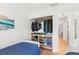 Bright bedroom featuring a closet with built-in storage and clothing racks, alongside wood flooring and neutral walls at 238 Sun Ketch Ct # 95, Treasure Island, FL 33706