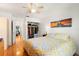 Cozy bedroom with hardwood floors, closet, a brightly colored bed, and an open doorway to another space at 238 Sun Ketch Ct # 95, Treasure Island, FL 33706