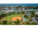 Aerial view of community amenities including ball field, tennis, playground, and pool at 238 Sun Ketch Ct # 95, Treasure Island, FL 33706