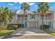 Charming townhouse with two stories, lush landscaping, and an inviting, private entrance with an attached garage at 238 Sun Ketch Ct # 95, Treasure Island, FL 33706