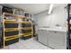 Laundry room featuring a washer, dryer, storage shelves, and tile flooring at 238 Sun Ketch Ct # 95, Treasure Island, FL 33706