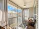 Cozy screened patio showcasing comfortable seating, sheer curtains, and a ceiling fan for relaxed outdoor living at 238 Sun Ketch Ct # 95, Treasure Island, FL 33706