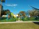 Community playground with colorful equipment and safety turf at 238 Sun Ketch Ct # 95, Treasure Island, FL 33706