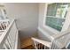 Stairwell with white railings, and a window that lets in natural light, creating an inviting entryway at 238 Sun Ketch Ct # 95, Treasure Island, FL 33706