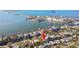 An aerial view shows the waterfront homes and proximity to the beach at 2451 Baywood W Dr, Dunedin, FL 34698