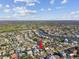 A breathtaking aerial view showcases the home's location near a canal, surrounded by lush greenery and residential neighborhoods at 2451 Baywood W Dr, Dunedin, FL 34698