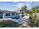 Backyard showcasing the pool area with brick pavers, lush landscaping and privacy fence at 2451 Baywood W Dr, Dunedin, FL 34698