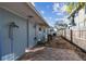 Outdoor space with a brick paver patio, outdoor shower, and a fenced yard at 2451 Baywood W Dr, Dunedin, FL 34698