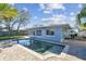 View of the swimming pool and lush green backyard at 2451 Baywood W Dr, Dunedin, FL 34698