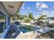 Outdoor pool with paver deck, fenced yard, and mature landscaping at 2451 Baywood W Dr, Dunedin, FL 34698