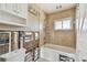 Bathroom featuring a tub, window, and vanity, with wood-look floors in the adjacent room at 2451 Baywood W Dr, Dunedin, FL 34698