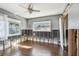 Bedroom with wood-look floors, two windows, and a sliding barn door at 2451 Baywood W Dr, Dunedin, FL 34698