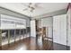 Bedroom with hardwood floors, ceiling fan, closet, and window undergoing repairs at 2451 Baywood W Dr, Dunedin, FL 34698