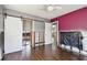 Bedroom with hardwood floors and barn door to closet undergoing repairs at 2451 Baywood W Dr, Dunedin, FL 34698