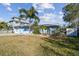 Charming single-story home featuring a well-maintained lawn, mature landscaping, and a freshly painted exterior at 2451 Baywood W Dr, Dunedin, FL 34698