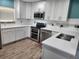 Modern kitchen featuring stainless steel appliances, white cabinetry, and countertops at 2451 Baywood W Dr, Dunedin, FL 34698