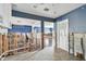 Open-concept living area featuring wood-look flooring, blue accent walls, and a view into the kitchen area at 2451 Baywood W Dr, Dunedin, FL 34698