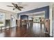 Living room with wood floors, ceiling fan, and view into an adjacent room at 2451 Baywood W Dr, Dunedin, FL 34698