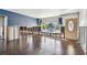 Bright living room with hardwood floors, large windows, and a view of the neighborhood at 2451 Baywood W Dr, Dunedin, FL 34698