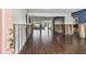 Large living space featuring wood floors, light walls, and a pass-through view into another room at 2451 Baywood W Dr, Dunedin, FL 34698