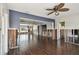 Open-concept living room featuring wood floors and natural light from large windows at 2451 Baywood W Dr, Dunedin, FL 34698