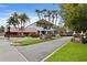 Charming neighborhood street scene with lush greenery and a view of local restaurants and shops in Dunedin at 2451 Baywood W Dr, Dunedin, FL 34698