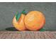 Unique mural featuring two vibrant oranges, set against a textured wall and paver sidewalk at 2451 Baywood W Dr, Dunedin, FL 34698