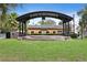 Charming city park with an amphitheater featuring a wrought iron awning and lush green lawns at 2451 Baywood W Dr, Dunedin, FL 34698
