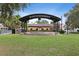 Charming city park with an amphitheater featuring a wrought iron awning and lush green lawns at 2451 Baywood W Dr, Dunedin, FL 34698