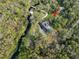Aerial view highlighting the home, creek, bridge, and serene natural surroundings at 2906 Pemberton Creek Dr, Seffner, FL 33584