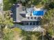Aerial view of brick home, pool area, lush landscaping, and long private driveway at 2906 Pemberton Creek Dr, Seffner, FL 33584
