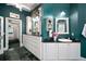 Bathroom featuring dual vanities, a walk-in closet, and a classic, timeless style at 2906 Pemberton Creek Dr, Seffner, FL 33584