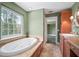 Bright bathroom featuring a large window, soaking tub, and detailed vanity at 2906 Pemberton Creek Dr, Seffner, FL 33584