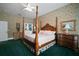 Charming bedroom featuring a four-poster bed, floral wallpaper and ample natural light at 2906 Pemberton Creek Dr, Seffner, FL 33584