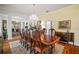 Large dining room featuring hardwood floors, chandelier, and seating for ten at 2906 Pemberton Creek Dr, Seffner, FL 33584