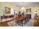 Spacious dining room with a fireplace, chandelier, and elegant furnishings at 2906 Pemberton Creek Dr, Seffner, FL 33584