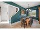 Bright dining room features a wooden table with seating for eight and adjacent staircase at 2906 Pemberton Creek Dr, Seffner, FL 33584