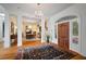 Grand foyer featuring hardwood floors, chandelier, and an open view to the formal dining room at 2906 Pemberton Creek Dr, Seffner, FL 33584