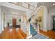 Grand foyer showcasing a sweeping staircase, hardwood floors, and a chandelier, creating an inviting entry at 2906 Pemberton Creek Dr, Seffner, FL 33584