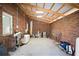 Large garage space with exposed brick walls and high ceilings with ample room for storage at 2906 Pemberton Creek Dr, Seffner, FL 33584