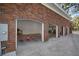 Spacious three-car garage featuring brick archways and ample parking space for vehicles and storage at 2906 Pemberton Creek Dr, Seffner, FL 33584