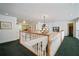 Hallway with white railing, carpeted floor, overhead lighting, and decorative chandelier at 2906 Pemberton Creek Dr, Seffner, FL 33584