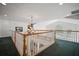 Upstairs hallway features decorative chandelier and overlooks the backyard pool at 2906 Pemberton Creek Dr, Seffner, FL 33584