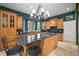 Gourmet kitchen featuring custom cabinetry, granite counters, stainless steel appliances, and a large central island at 2906 Pemberton Creek Dr, Seffner, FL 33584