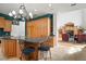 Open-concept kitchen with an island, granite countertops, stainless steel appliances, and adjacent living area at 2906 Pemberton Creek Dr, Seffner, FL 33584