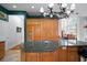 Open kitchen features an island with bar seating, custom cabinets, and modern appliances at 2906 Pemberton Creek Dr, Seffner, FL 33584