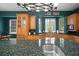 Kitchen featuring custom cabinets, granite countertops, a large central island, and high-end appliances at 2906 Pemberton Creek Dr, Seffner, FL 33584